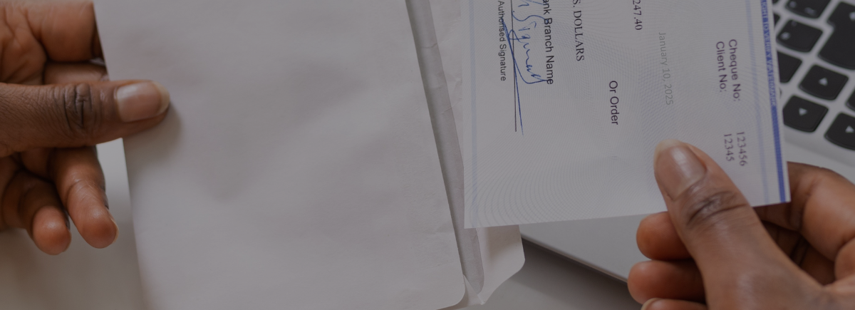 Radiologist pulls a paycheck out of an envelope